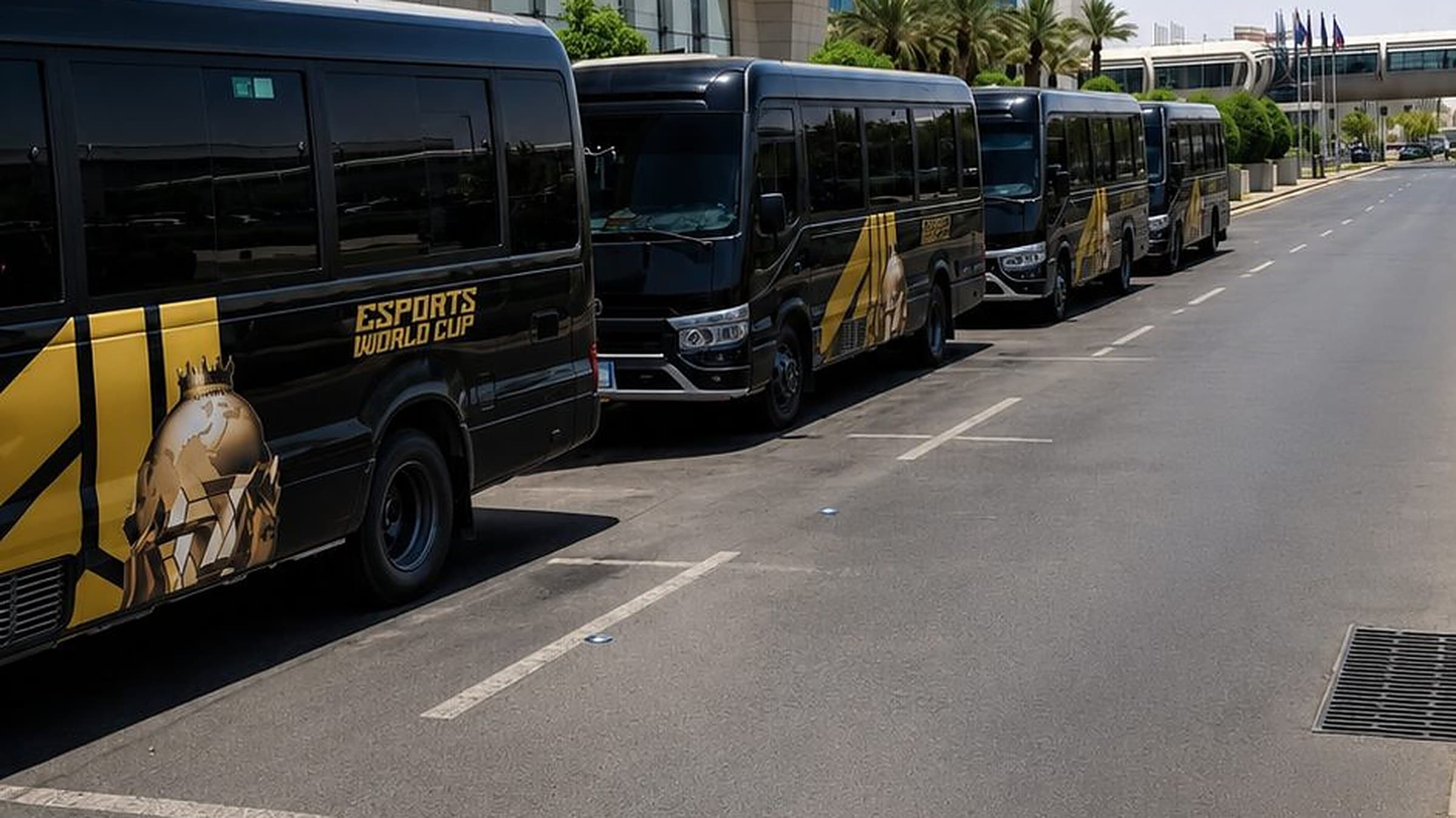 City to city chauffeur Saudi Arabia, black CHAUFFIQ Coaster buses in Esports World Cup livery lined up outside a Riyadh hotel