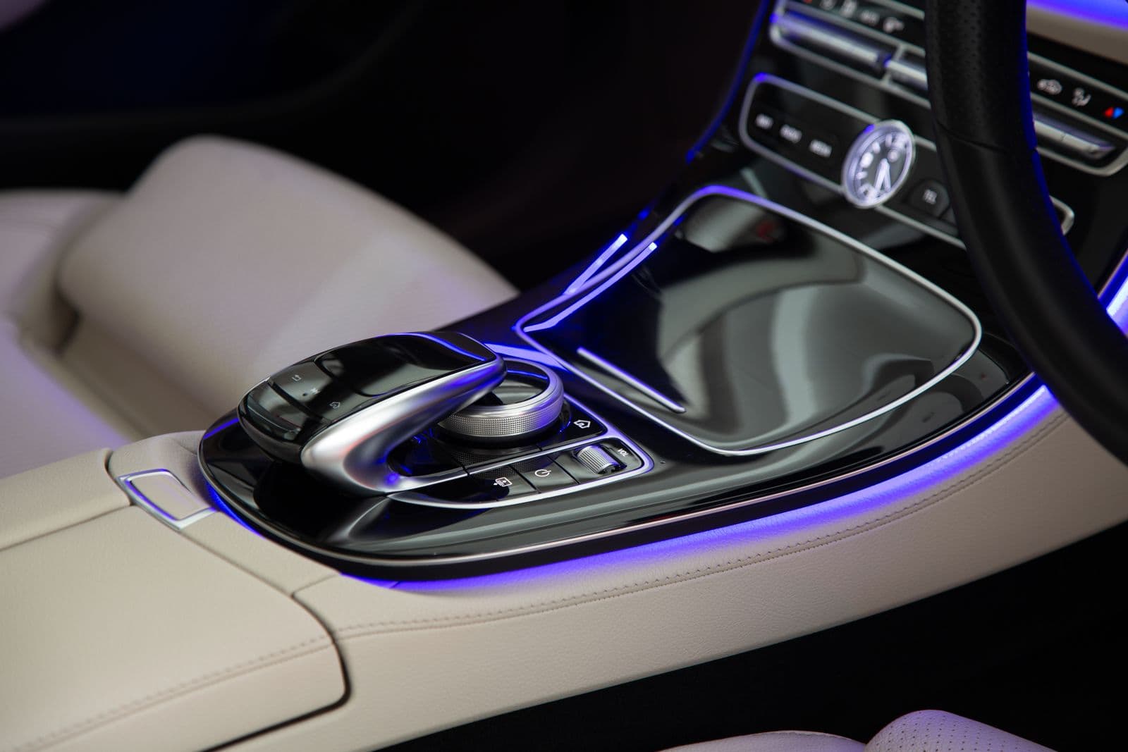 Ambient-lit centre console of a chauffeured Mercedes, the cabin of an as-directed booking