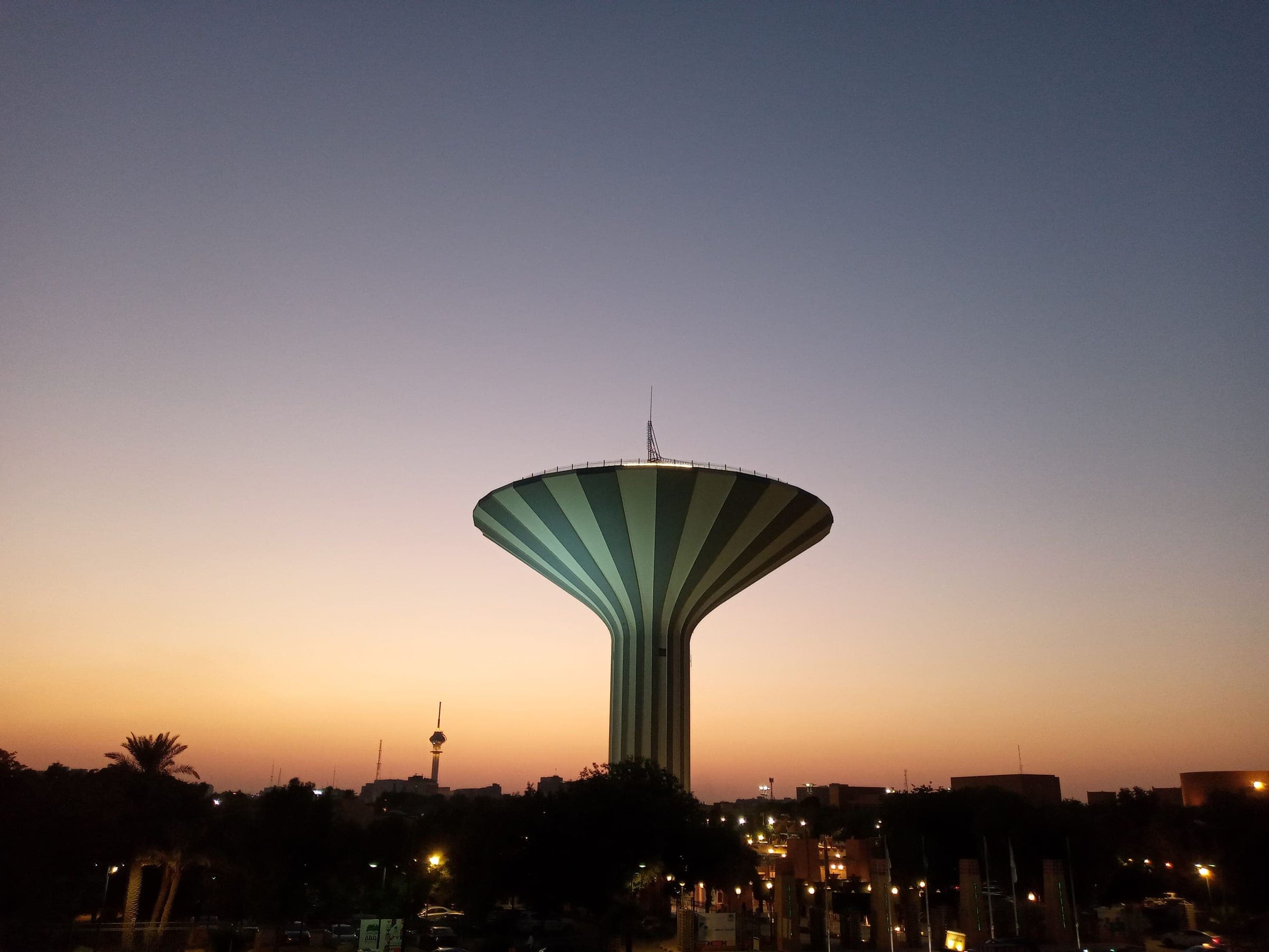 The Riyadh Water Tower against a dusk sky, the hour a city day in Riyadh is timed around