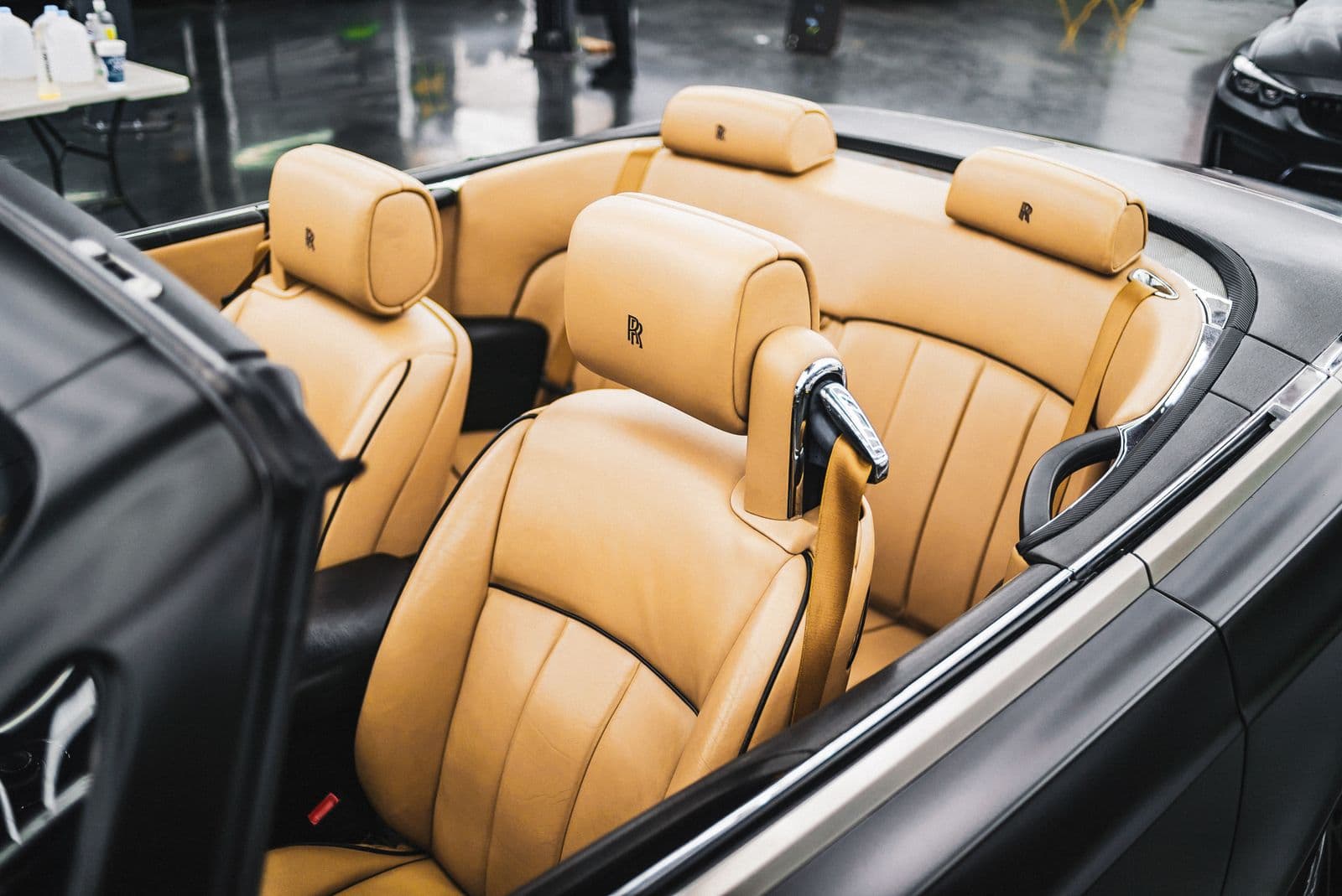Tan leather rear seats of a Rolls-Royce, the car a hotel keeps for its own guests