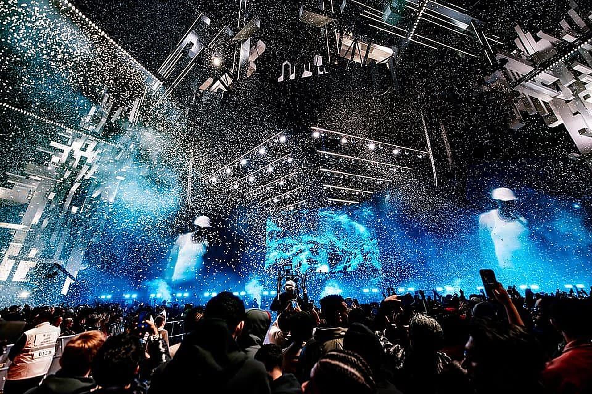 The Soundstorm festival ground outside Riyadh lit at night, crowds moving between the stages