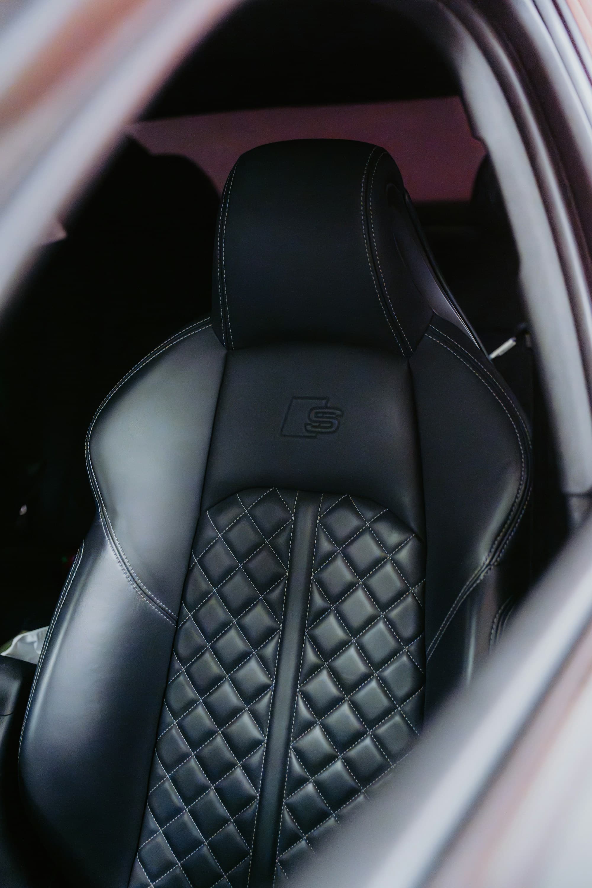 Black leather seat detail with diamond stitching