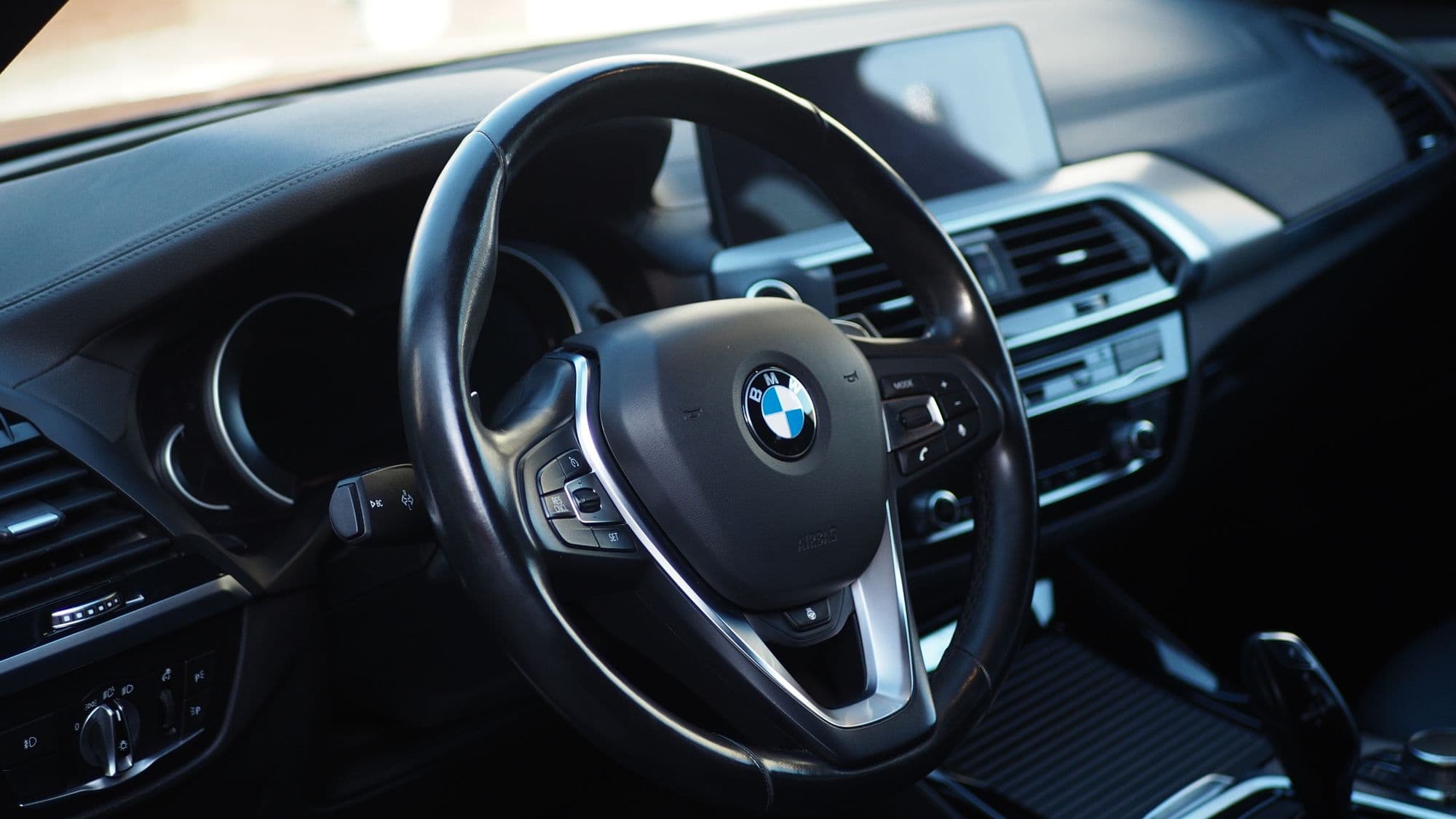 BMW dashboard in black with the widescreen display lit
