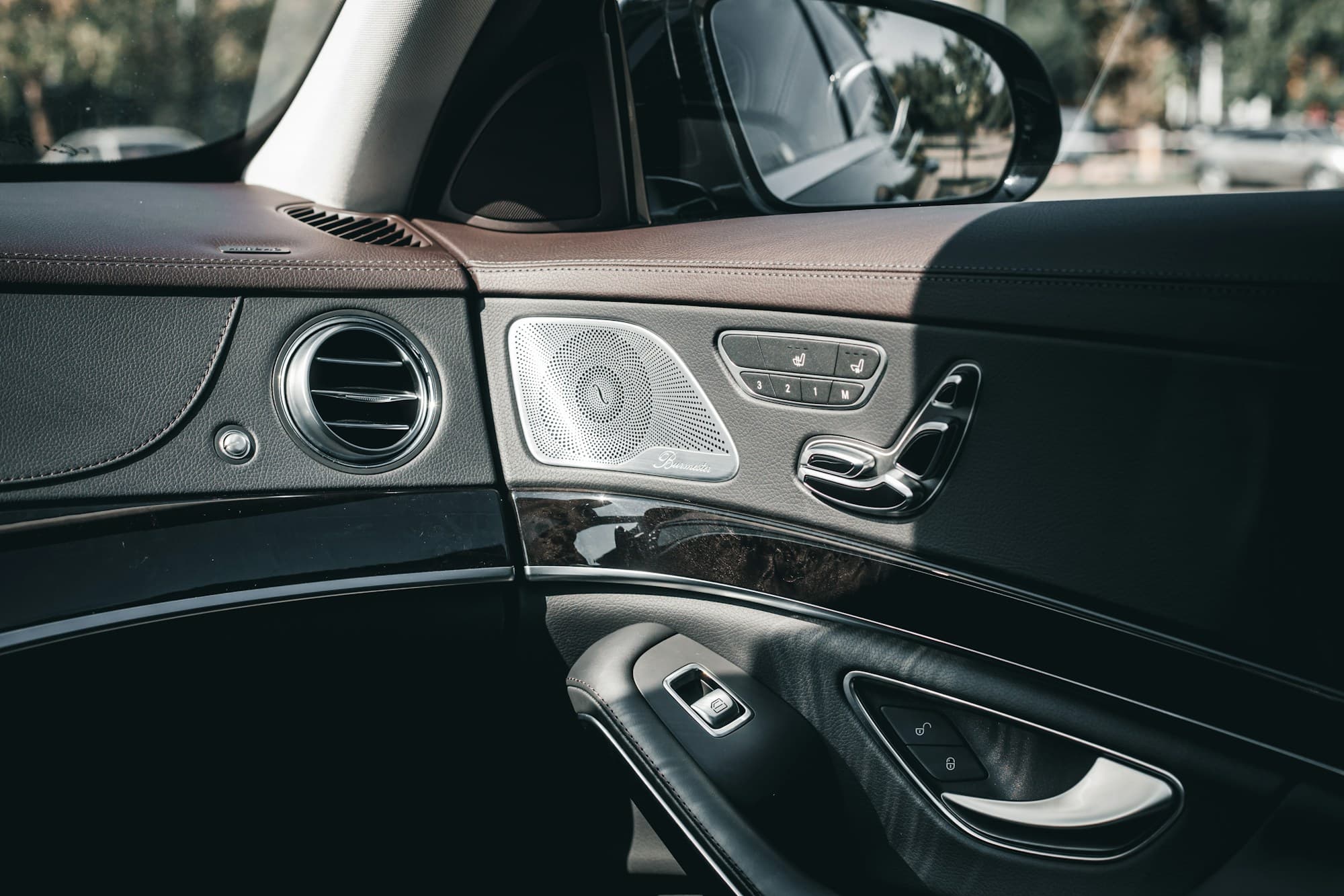 Black door panel with the window controls, speaker and air vent