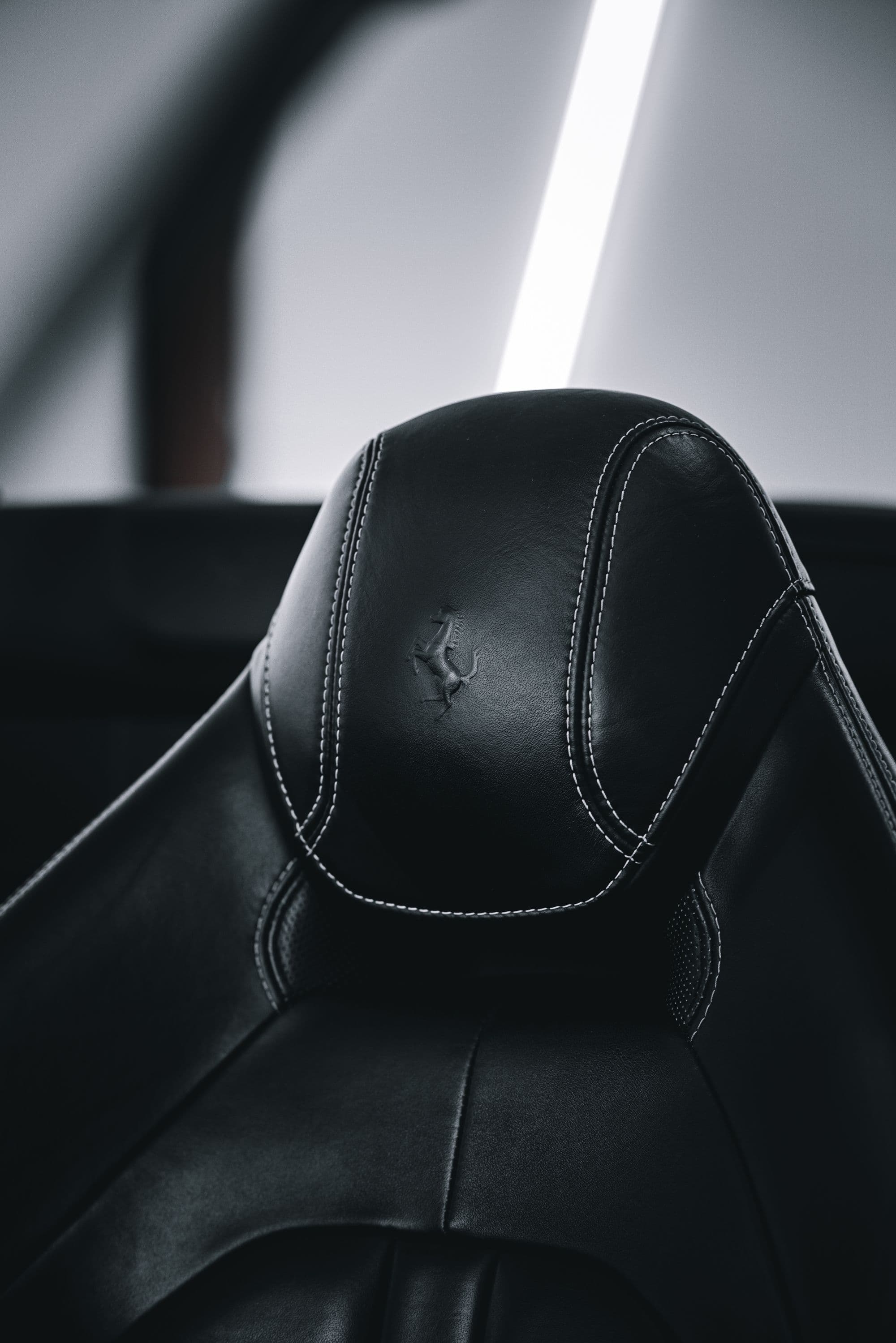Black leather headrest with contrast stitching