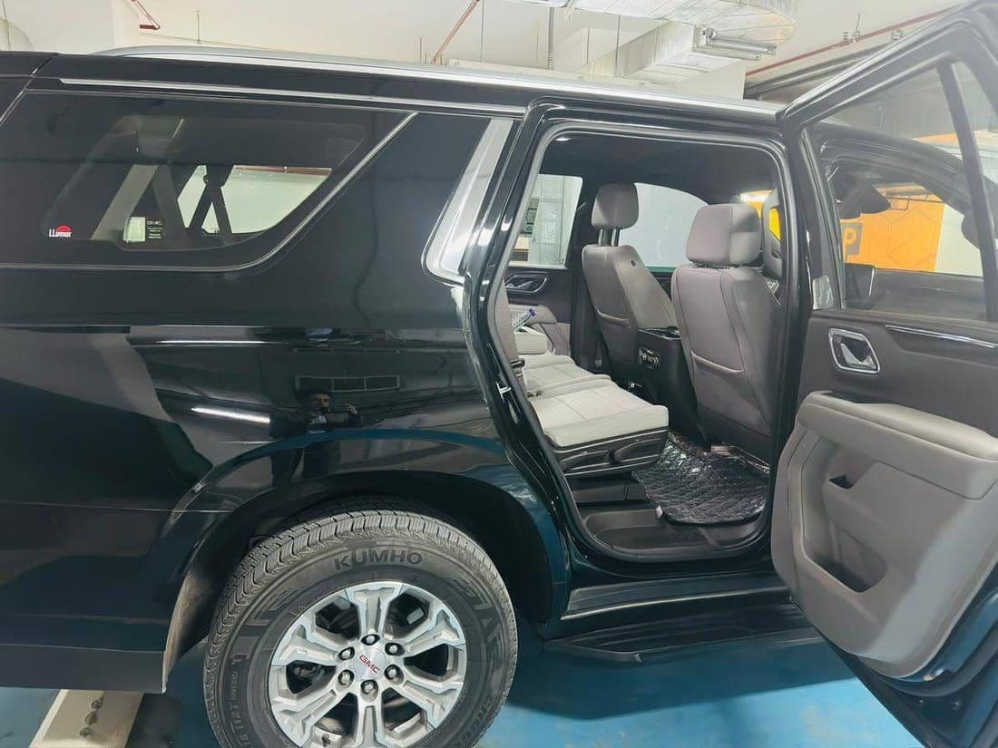 CHAUFFIQ own-fleet GMC SUV with the rear door open