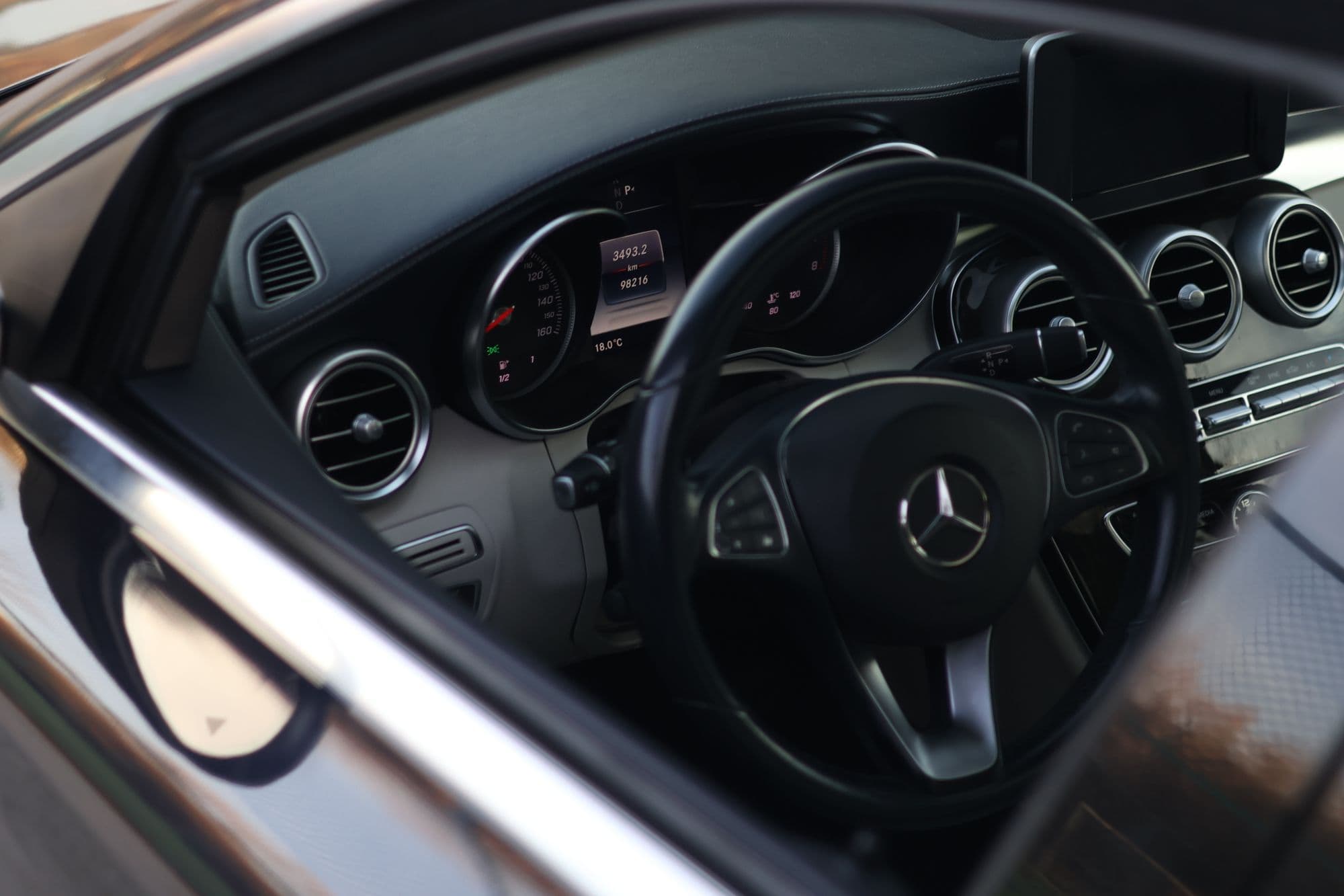 Mercedes-Benz cockpit in black with the wheel and vents in view