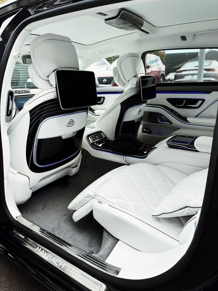 Rear cabin of a Mercedes-Benz S-Class in white leather, a VIP car for a Jeddah Season night