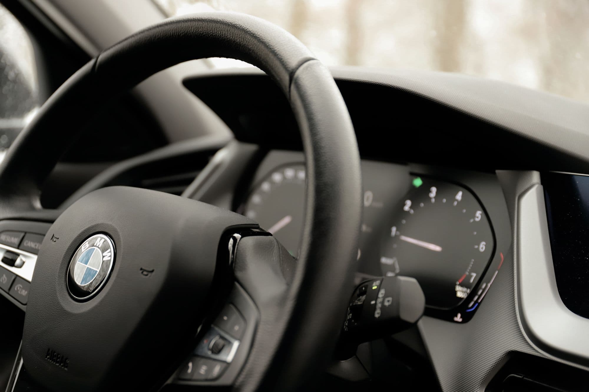 Mercedes-Benz wheel and digital cluster lit in a black cockpit