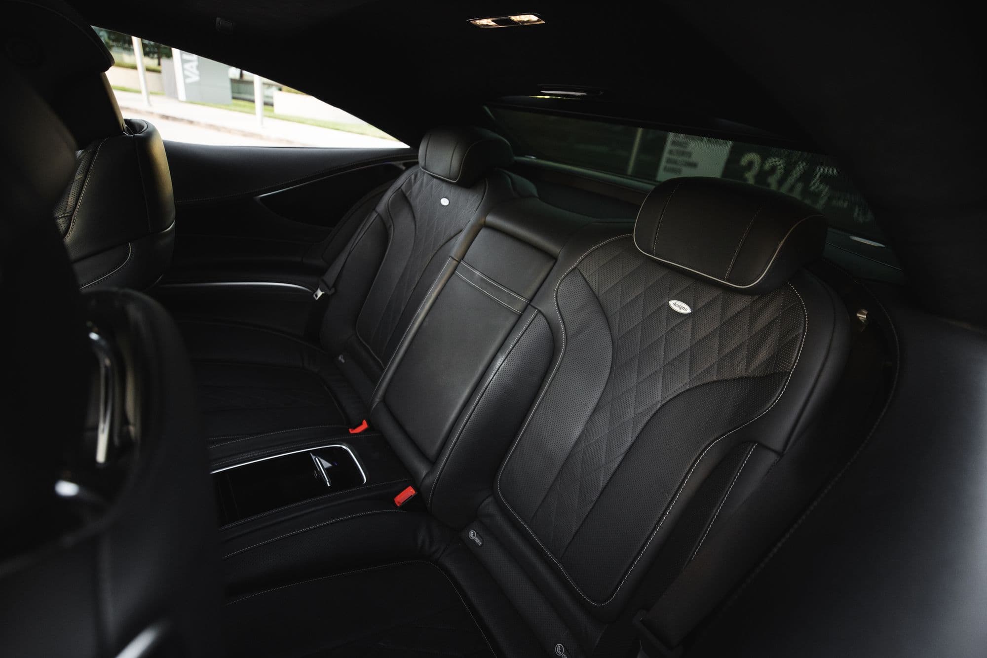 Black quilted rear seat seen from the open door