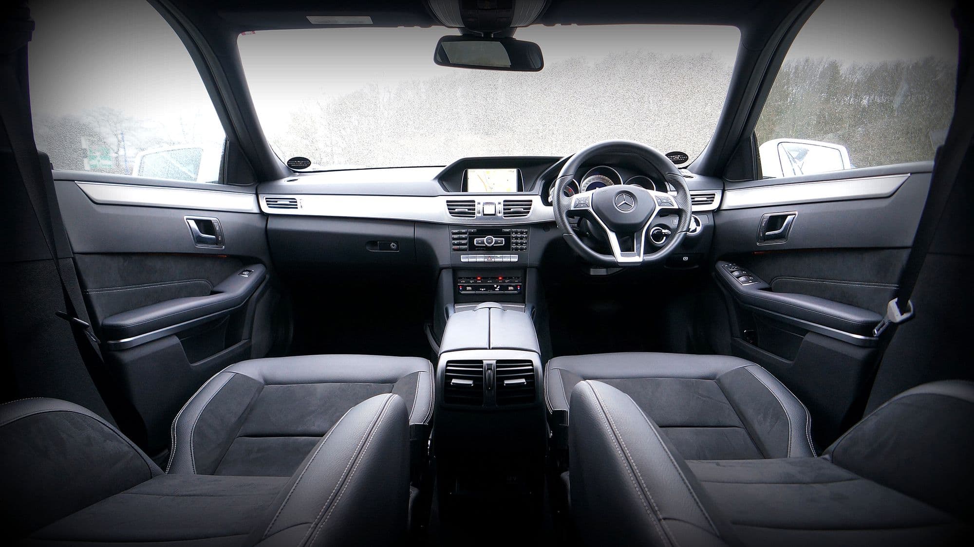 Saloon cabin in black seen from the rear seat, both front seats in view