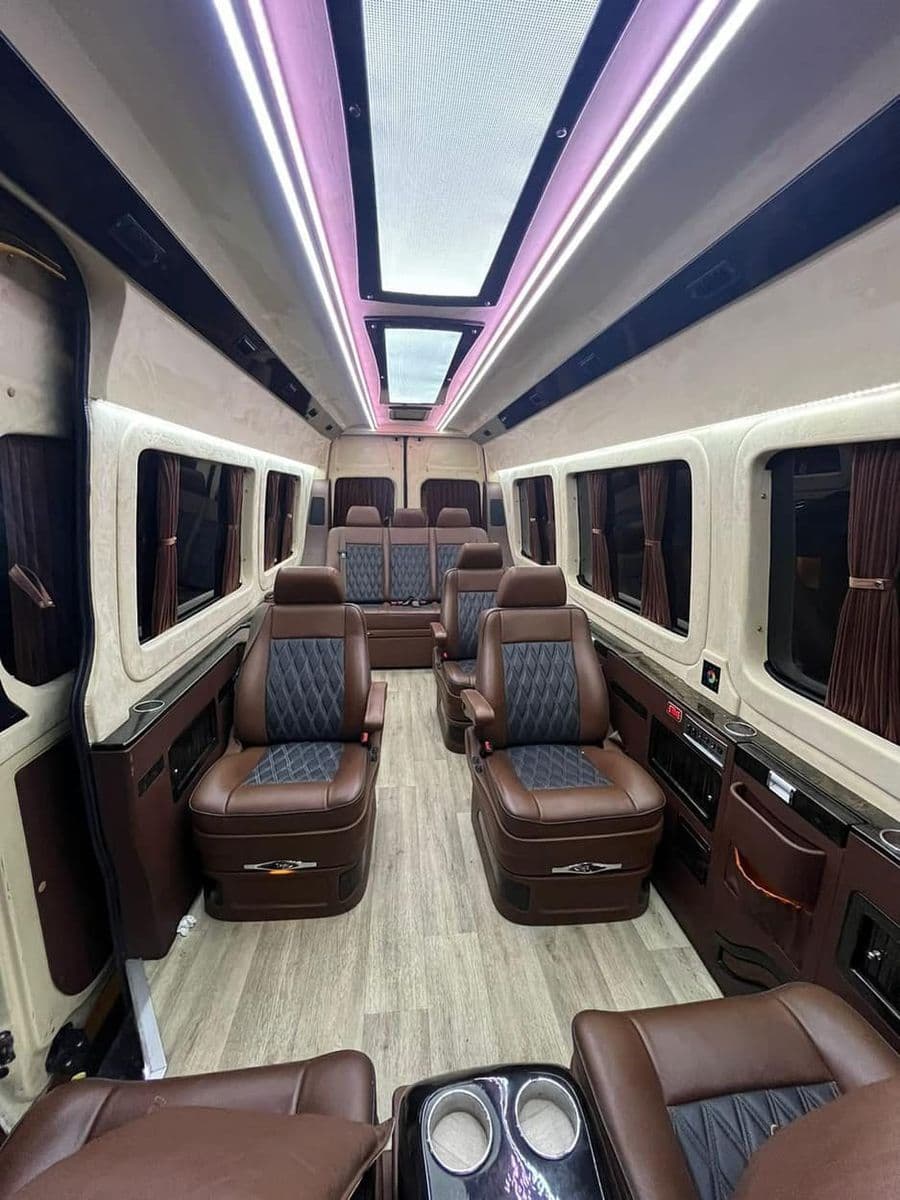 Sprinter VVIP quilted armchairs in dark hide under a panoramic roof