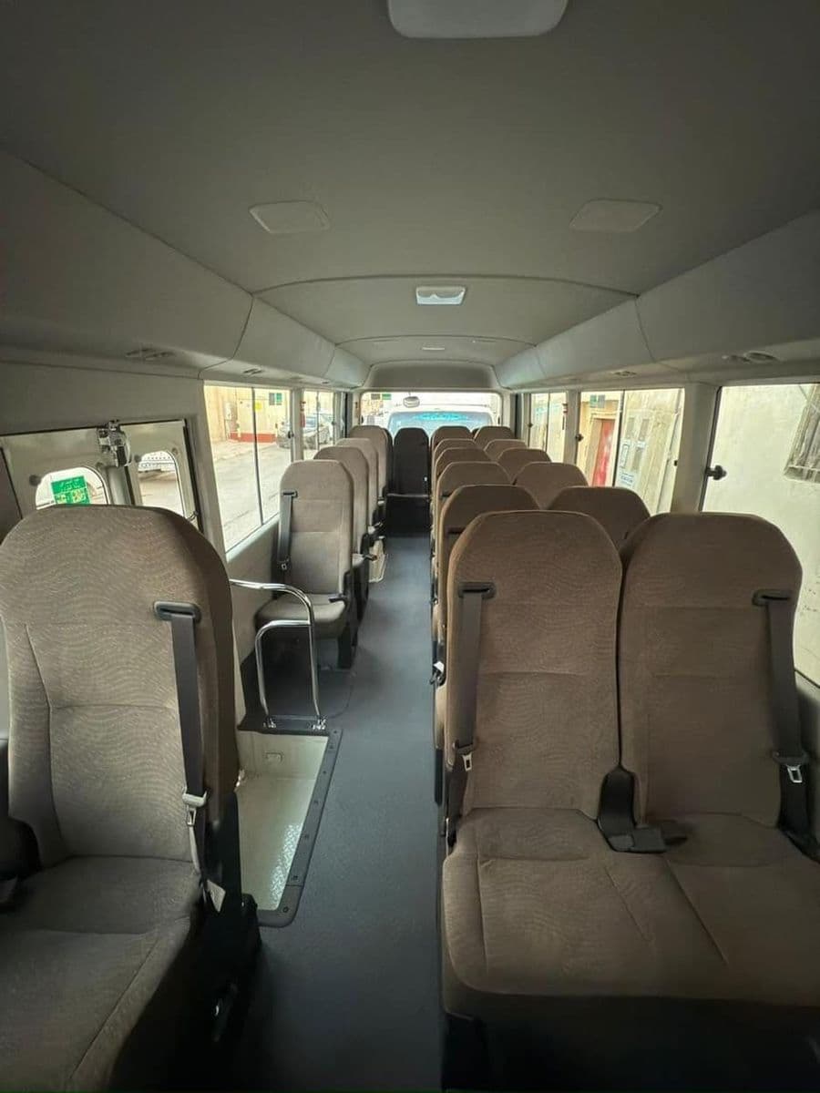 Toyota Coaster cabin, twenty-two seats with a centre aisle, CHAUFFIQ own vehicle