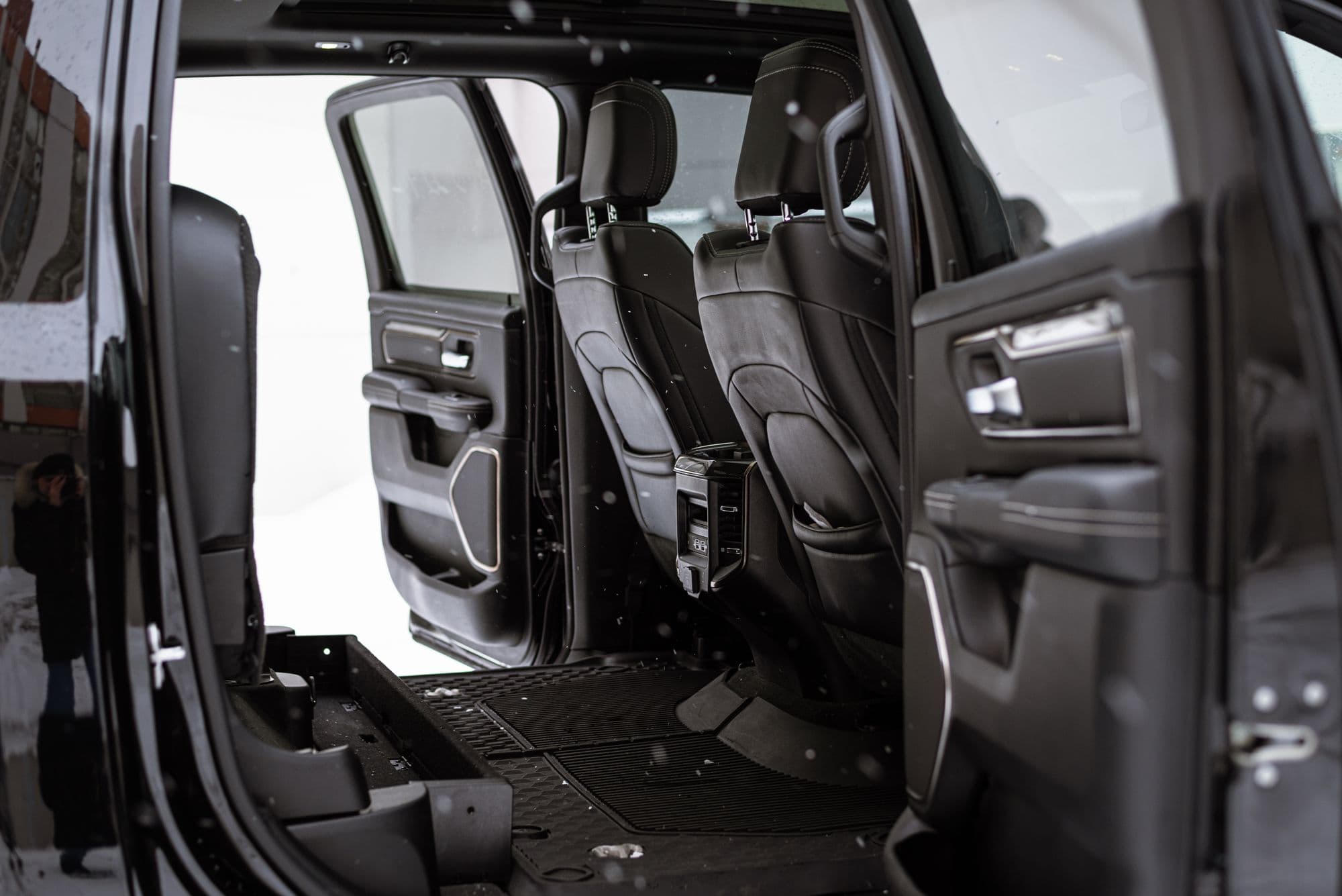 Black van cabin with the side door open onto the seats
