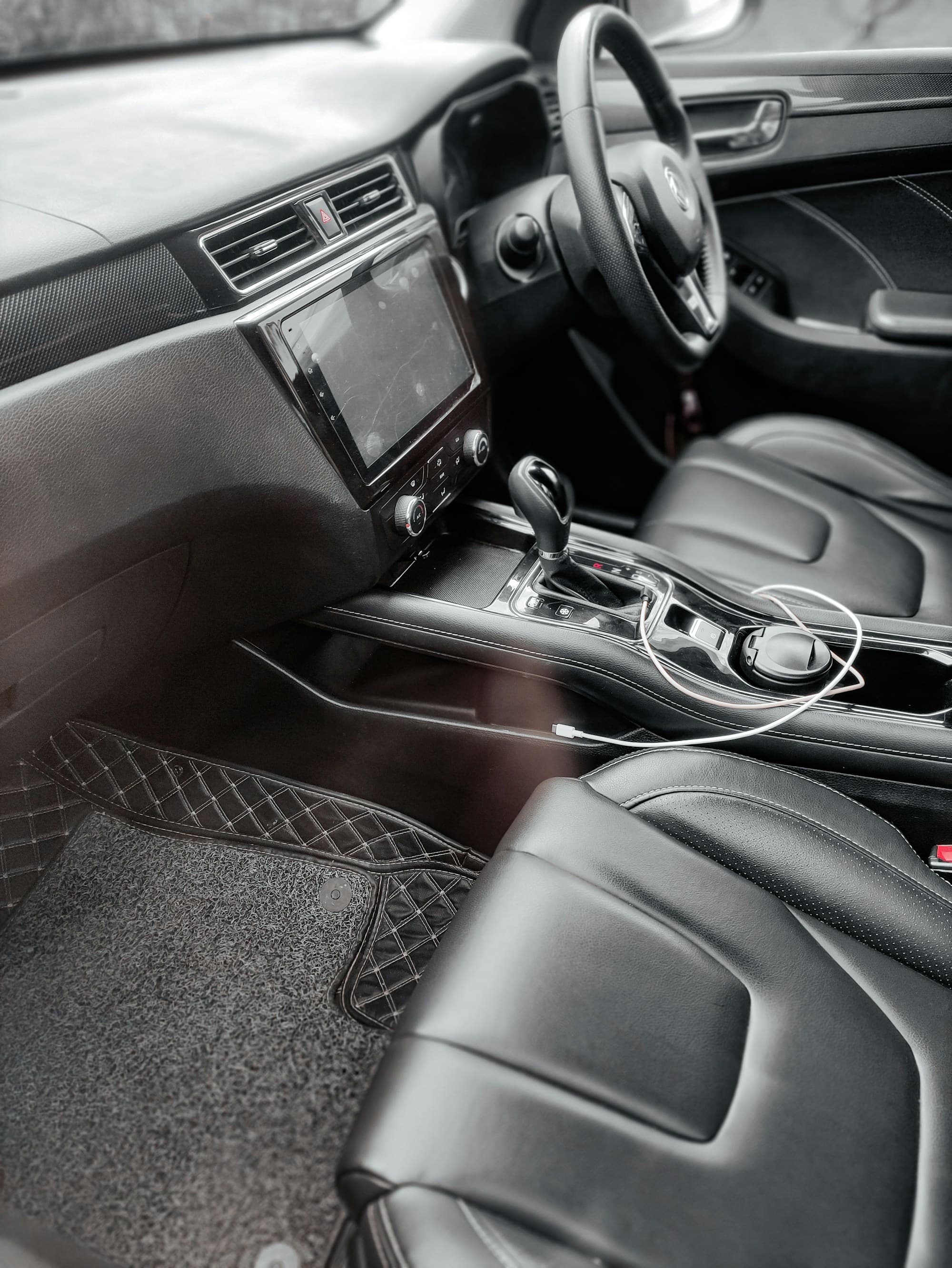 Black leather console and front seats of a people-mover